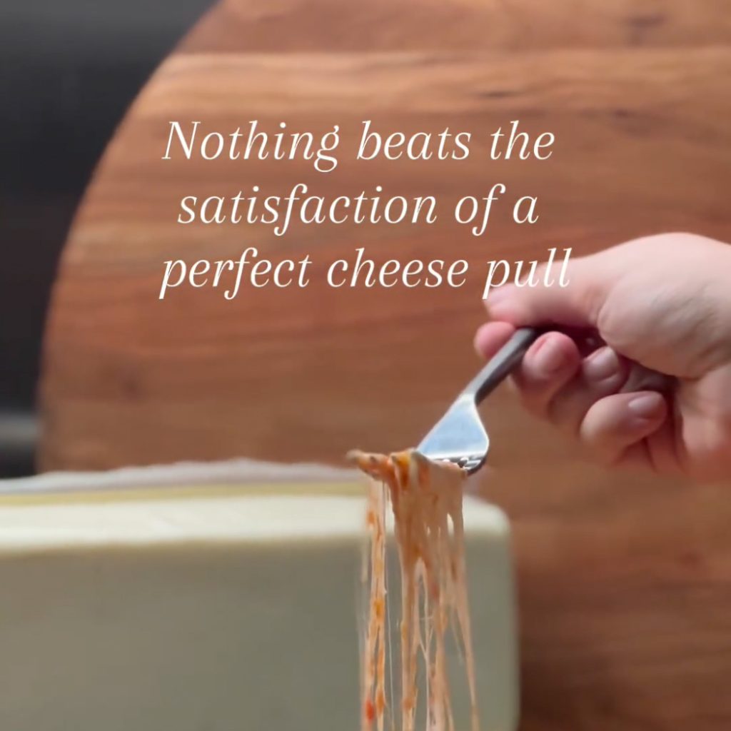 still from video showing cheese pull with fork