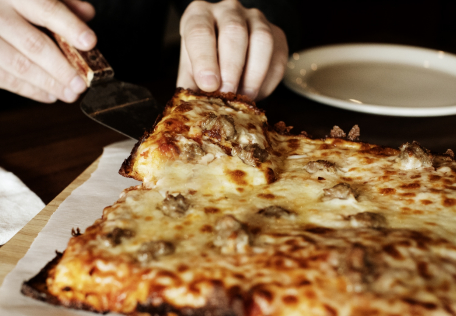 Serving Detroit Style pizza with Bacio cheese