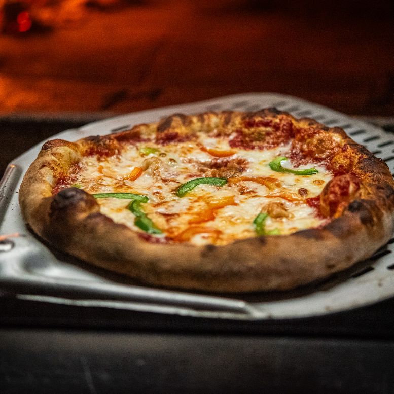 Masonry panel 1, pizza with Bacio cheese coming out of a wood-fired oven